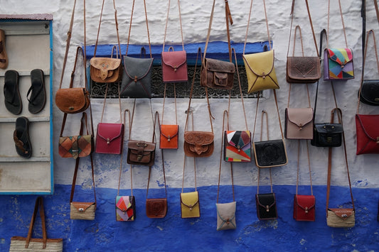 Assortment of small leather bags hanging on wall