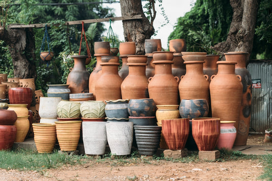 A large collection of terracotta and ceramic pots displayed outdoors.