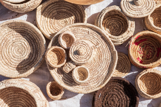 A collection of handmade woven baskets and trays.